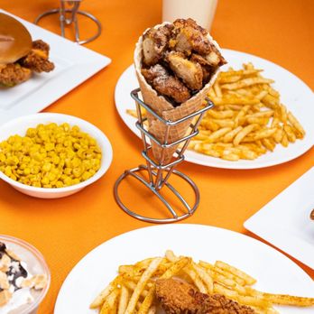 Chick'nCone - a variety of food items on a table - Chicken Shop Near Me - Estero, Florida