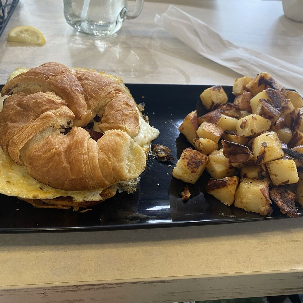 EggTown - Bacon egg and cheese croissant sandwich with a side of potatoes - Breakfast & Brunch Near Me - Palm Harbor, Florida EggTown - Bacon egg and cheese croissant sandwich with a side of potatoes - Breakfast & Brunch Near Me - Palm Harbor, Florida