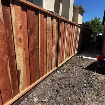 Alexander's Pavers - a wooden fence in a backyard - Landscaping Near Me