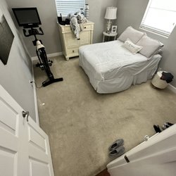 Luis Quintero - Client's guest bedroom with old carpeting prior to removal and installation of vinyl plank flooring.