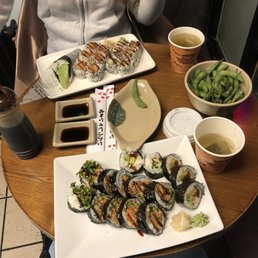 Top plate: avocado hand roll, sweet potato tempura roll, dynamite roll Bottom plate: spider roll, futomaki roll Top plate: avocado hand roll, sweet potato tempura roll, dynamite roll Bottom plate: spider roll, futomaki roll