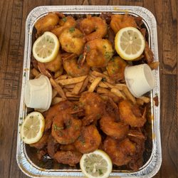 Zamar Restaurants - Shrimp and wings, half sweet sauce and half hot sauce plus Haitian fries and Haitian blue cheese.