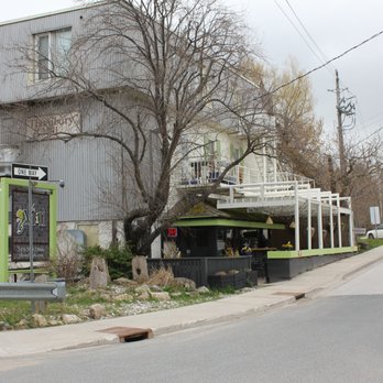The Mill Cafe - The outside sitting area is the lower level, and you enter inside through the doors beneath the OPEN sign. There must be apartments above? - Steakhouses Near Me - Thornbury, Ontario