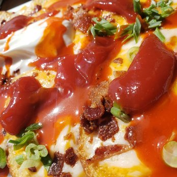 Hennessey's Tavern - Irish nachos with added chalula & ketchup - Irish Pub Near Me - Manhattan Beach, California Hennessey's Tavern - Irish nachos with added chalula & ketchup - Irish Pub Near Me - Manhattan Beach, California