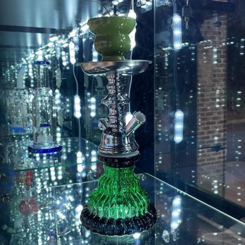 Got Smoke - a glass display case with a green glass cup on top - Vape Shops Near Me - Fairburn, Georgia