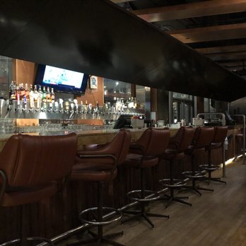 Rudy's Eat & Drink - a row of leather chairs at a bar - American Near Me - Winnipeg, Manitoba Rudy's Eat & Drink - a row of leather chairs at a bar - American Near Me - Winnipeg, Manitoba