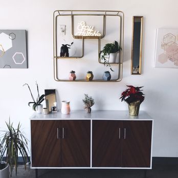 Cohesive Coffee - a sideboard with plants on it - Coffee & Tea Near Me - Greenville, South Carolina