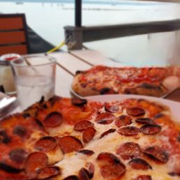 Pepperoni pizza and view of the lake. Pepperoni pizza and view of the lake.