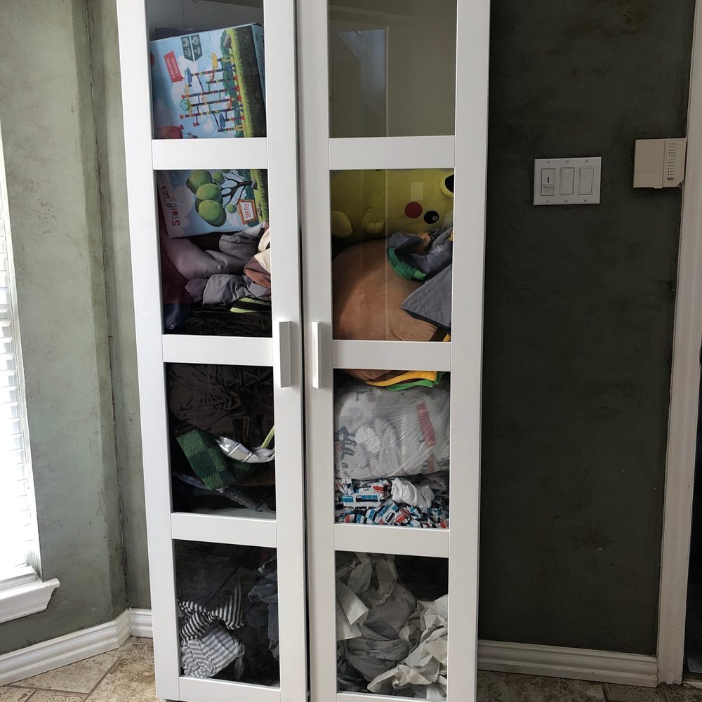 Broken Ikea Cabinet stuffed full of clothes due to their lack of estimate and poor packing.