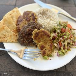 Beef and chicken kofta with rice, salad and pita bread