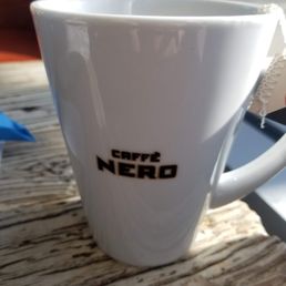 a white coffee cup on a wooden table