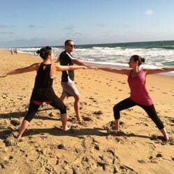 Aloha Yoga - Family of Warriors in Warrior II. Two students beginners.