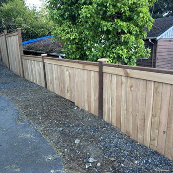 Top Rail Fence - Seattle - Side portion of fence, built along an incline, dropping off towards our neighbors property. - Fences & Gates Near Me Top Rail Fence - Seattle - Side portion of fence, built along an incline, dropping off towards our neighbors property. - Fences & Gates Near Me