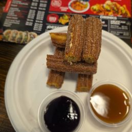 Churros with raspberry sauce and caramel on the side