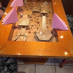 Delta - Tables inset with traditional decorations.