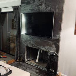 a living room with a fireplace and a flat screen tv a living room with a fireplace and a flat screen tv