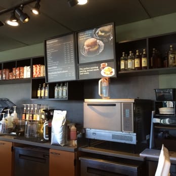 Starbucks - a coffee shop counter with a menu on the wall - Coffee & Tea Near Me - Vancouver, British Columbia Starbucks - a coffee shop counter with a menu on the wall - Coffee & Tea Near Me - Vancouver, British Columbia