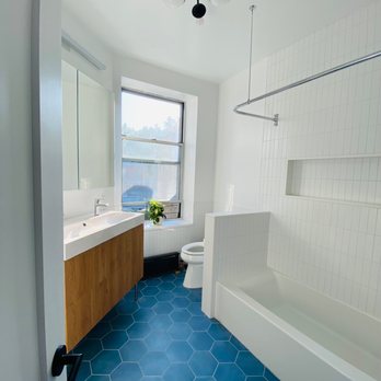 LEY Home Improvements - a bathroom with a blue floor - General Contractors Near Me - Queens, New York