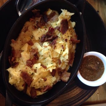 Mash'D - Mash'd Tator Explosion - brunch item skillet with mashed potatoes, melted cheddar cheese, scrambled eggs and bacon - New American Near Me - Frisco, Texas