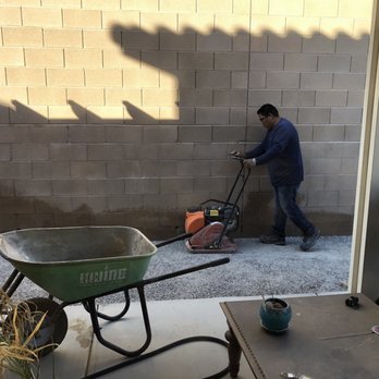 Alvarado's Creations - a man pushing a wheelbarrow - Landscaping Near Me - Las Vegas, Nevada
