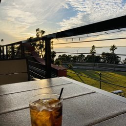 a drink on a table overlooking the ocean
