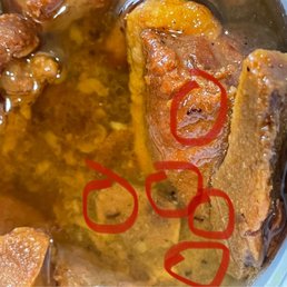 A handful of ants inside the pork meat dish A handful of ants inside the pork meat dish