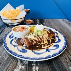 Cactus Grill - Dive into our Fajita Burrito, packed with sizzling fajita meat and veggies, and drizzled with our famous New Mexico red chile sauce.