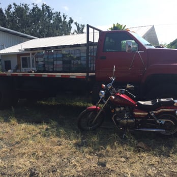 Big Island Bees - Bee crates beyond the truck bed (and a cool motorcycle) - Honey Near Me - Captain Cook, Hawaii