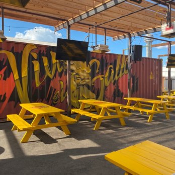 Viva El Gallo - a row of yellow picnic tables - Mexican Near Me - Dallas, Texas Viva El Gallo - a row of yellow picnic tables - Mexican Near Me - Dallas, Texas