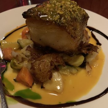 Carmelina's - Pistachio garlic roasted fresh Chilean sea bass in a saffron sauce with roasted vegetables! - Italian Near Me - Boston, Massachusetts Carmelina's - Pistachio garlic roasted fresh Chilean sea bass in a saffron sauce with roasted vegetables! - Italian Near Me - Boston, Massachusetts