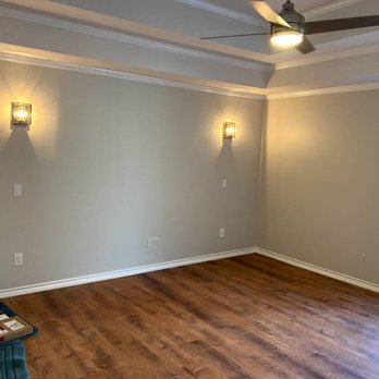 JGI Renovations - a living room with hard wood floors - Painters Near Me