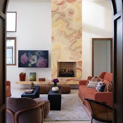 cg interiors group - An onyx fireplace takes center stage in this warmly designed family room.