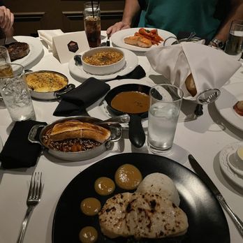 Porch and Parlor - Miso Chilean Sea Bass, sweet potatoes, au poivre sauce, creamed corn brûlée, Mac & cheese, prime ribeye. Bread basket & butter. Salmon. - Steakhouses Near Me - Memphis, Tennessee