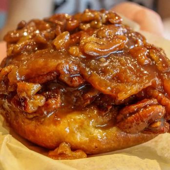 Flour Bakery + Cafe - a person holding a pastry - Coffee & Tea Near Me - Cambridge, Massachusetts