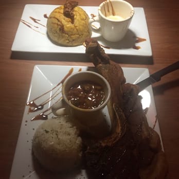 Platos - My skirt steak MUFONGO with white garlic sauce on the side. My husbands pork can can with rice & beans. - Latin American Near Me - Carolina, Puerto Rico