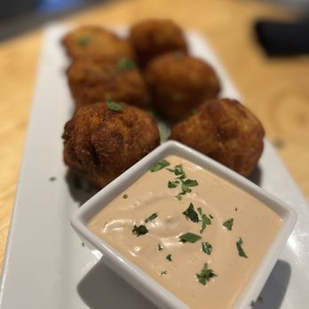 Wheelhouse Downtown - MAC & CHEESE FRITTERS Elbow macaroni and smoked jalapeño cheese sauce breaded and fried with a roasted garlic sauce - Burgers Near Me - Saint Louis, Missouri Wheelhouse Downtown - MAC & CHEESE FRITTERS Elbow macaroni and smoked jalapeño cheese sauce breaded and fried with a roasted garlic sauce - Burgers Near Me - Saint Louis, Missouri