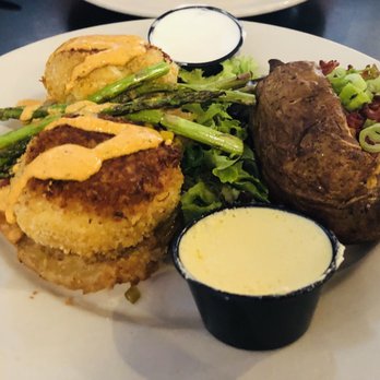 Manning's Restaurant - Crab Cakes on top of fried green tomatoes w/ a side of asparagus and loaded baked potato. The sauces are homemade as well. - American Near Me - Clayton, North Carolina Manning's Restaurant - Crab Cakes on top of fried green tomatoes w/ a side of asparagus and loaded baked potato. The sauces are homemade as well. - American Near Me - Clayton, North Carolina