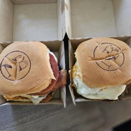 This is the Three meats breakfast sandwich on the left and the porchetta breakfast sandwich on the right. This is the Three meats breakfast sandwich on the left and the porchetta breakfast sandwich on the right.