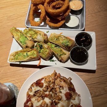 BJ's Restaurant & Brewhouse - Onion rings (the siracha dipping sauce was amazing), avocado egg rolls, white pizza. Mac n cheese bites not pictured. - Breweries Near Me - Superstition Springs, Arizona BJ's Restaurant & Brewhouse - Onion rings (the siracha dipping sauce was amazing), avocado egg rolls, white pizza. Mac n cheese bites not pictured. - Breweries Near Me - Superstition Springs, Arizona