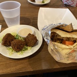 Chicken shawarma in a pita with a side order of  falafel.