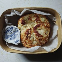 Toasted Asiago bagel with cream cheese.