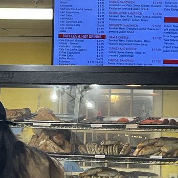 The Cuban Cafe And Bakery - a woman standing in front of the counter - Cuban Near Me - St. Augustine, Florida