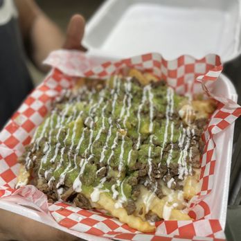 Tacos El Güero - a person holding a tray of food - Tacos Near Me - Arcadia, California