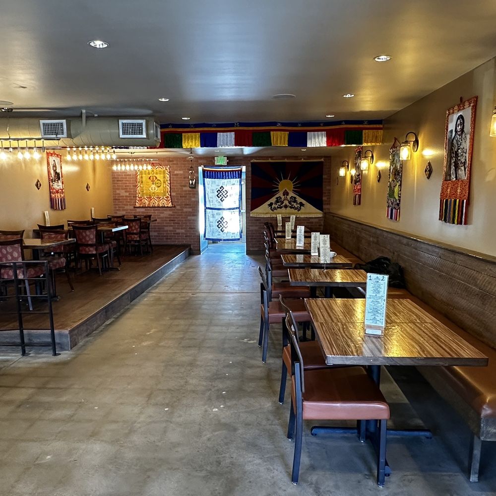 Little Tibet - the inside of a restaurant with tables and benches - Indian Near Me - Boulder, Colorado