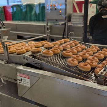 Krispy Kreme - Donuts draining from the oil - Desserts Near Me - Toronto, Ontario