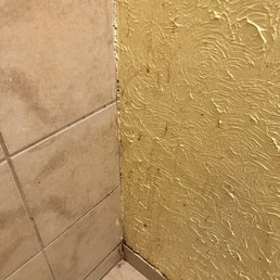 Splatter stains on the wall and baseboard.