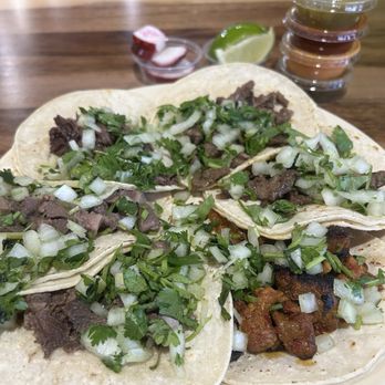 Tacos Selene - - Lengua - Tongue, Carne Asasda - Beef and Alpastor - Pork with Pineapple - Three tacos with beef, topped with chopped onions and cilantro, served with side sauces, lime wedge, and small containers of salsa or sauce. - Mexican Near Me - Aurora, Colorado