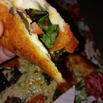 New York Pizza - a hand holding a slice of pizza - Pizza Near Me - West Bridgewater, Massachusetts