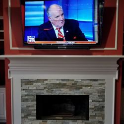 Benchmark Communications - TV mounted above fireplace with soundbar bracket and wire concealment
