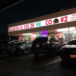 cars parked in front of a restaurant cars parked in front of a restaurant